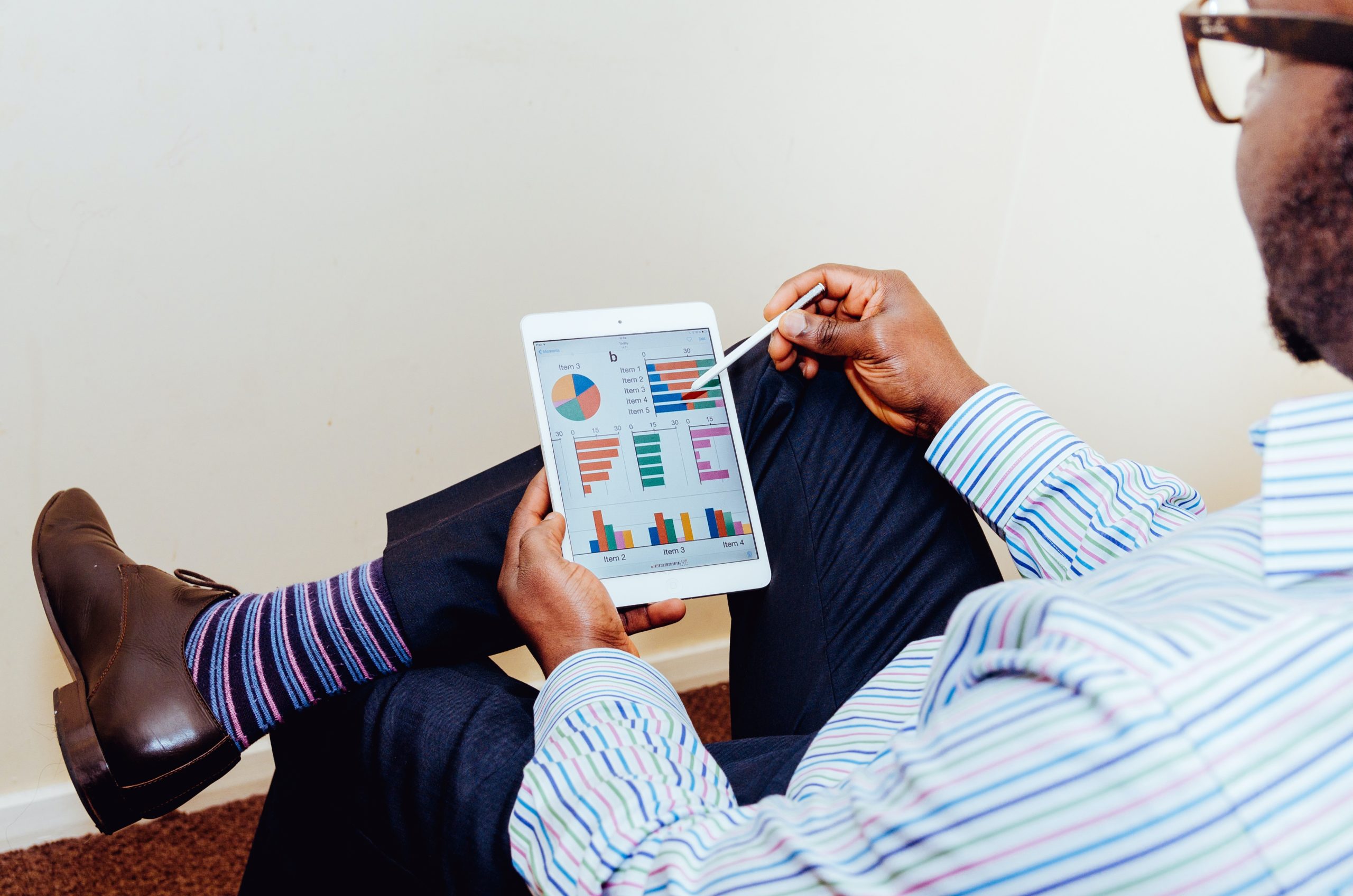 Man Viewing Charts On Tablet